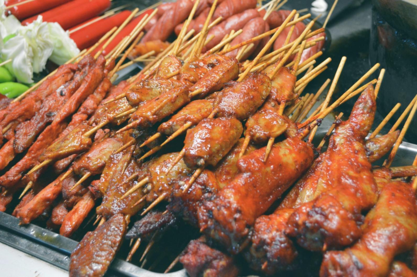 Workshop participant learning proper garnish placement and sauce application techniques during hands-on training session