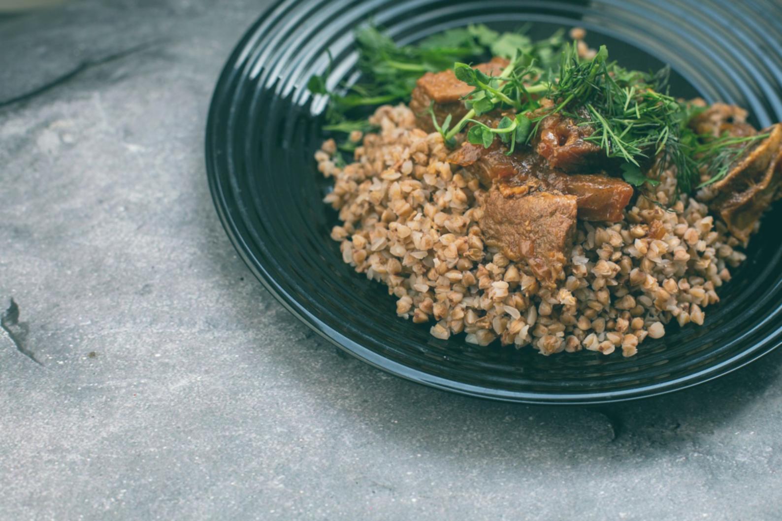 Close-up demonstration of height-building techniques using protein stacking and vegetable arrangement methods